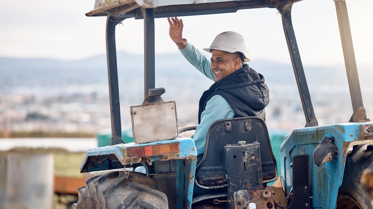 wave-greeting-and-man-on-a-tractor-for-farming-a-2023-11-27-05-11-32-utc-1.webp